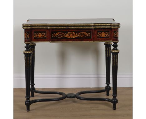 A LATE 19TH CENTURY MARQUETRY INLAID GILT METAL MOUNTED EBONISED AND AMBOYNA FOLD OVER CARD TABLEOn tapering fluted supports,
