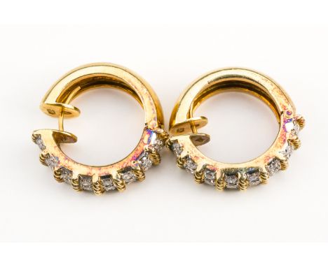 A PAIR OF GOLD AND DIAMOND HOOP SHAPED EARRINGSEach front mounted with eight three stone diamond divisions mounted with round