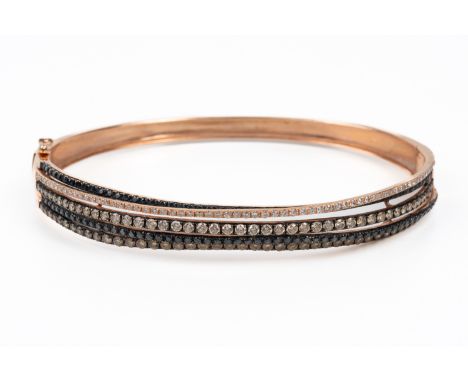 A BLACK AND WHITE DIAMOND BANGLEThe bangle set with multiple rows of black and white diamonds, mounted in 14ct rose gold, ins