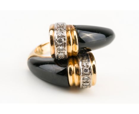 A GOLD, DIAMOND AND BLACK ONYX RINGIn a twistover design, each curved end mounted with a row of five round brilliant cut diam