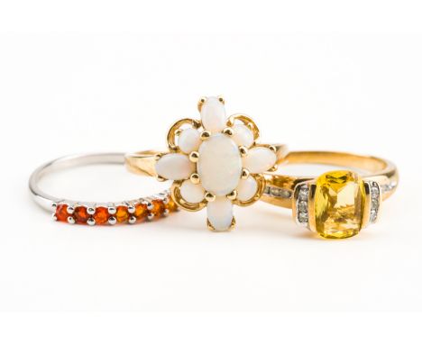 A 9CT GOLD AND OPAL NINE STONE CLUSTER RING AND TWO FURTHER RINGS (3)The opal ring mounted with oval and circular opals, ring