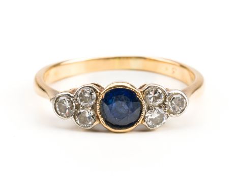 A GOLD, SAPPHIRE AND DIAMOND RINGCollet set with a cushion shaped sapphire between collet set cushion shaped diamond three st