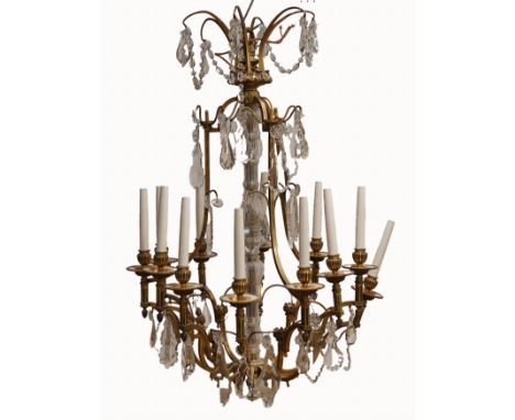 A LOUIS XV STYLE CARTOUCHE SHAPED METAL AND GLASS  TWELVE LIGHT CHANDELIERLate 20th Century 
Hung with pear-shaped drops and 