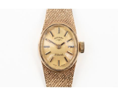 A ROTARY 9CT GOLD LADY'S BRACELET WRISTWATCHThe signed oval gilt dial with baton hour markers, on a tapered woven link bracel