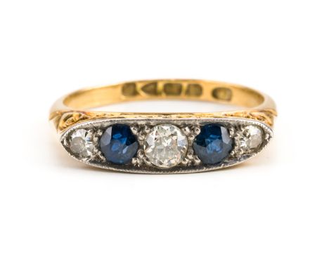 AN 18CT GOLD SAPPHIRE AND DIAMOND FIVE STONE RINGMounted with two cushion shaped sapphires, alternating with three cushion sh