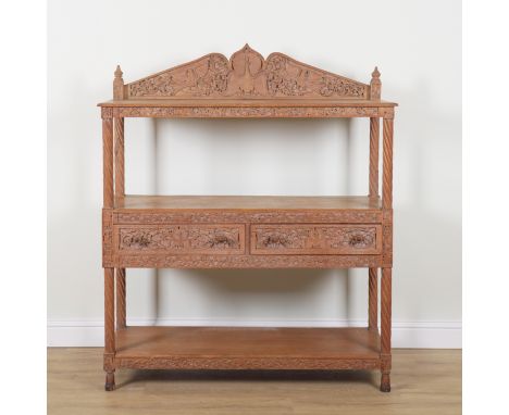 A 19TH CENTURY ANGLO INDIAN CARVED TEAK THREE TIER BUFFETWith two central drawers, 140cm wide; 46cm deep; 165cm high