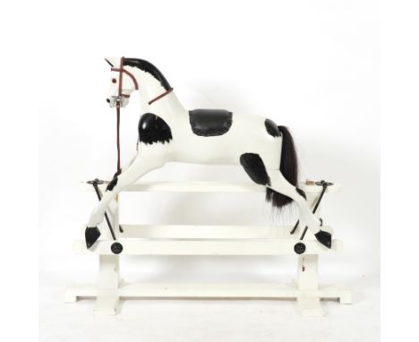 A PAINTED PIEBALD ROCKING HORSEModern
The base, 132.5cm wide; 43cm deep; 114cm high overall