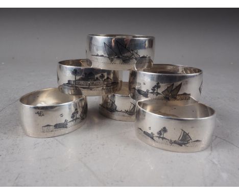 A set of six Eastern white metal napkin rings with niello enamel landscape decoration, 3.8oz troy approx 