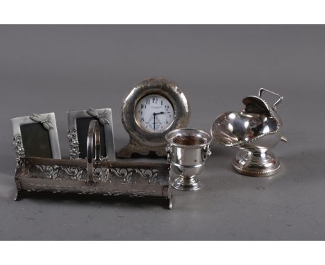 A silver framed clock with white enamel dial and Arabic numerals, retailed by Ollivant &amp; Botsford, Manchester, 5" high, a