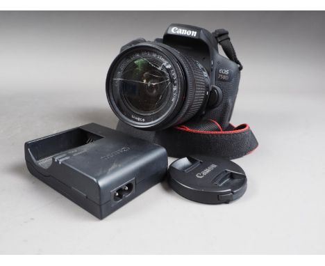 A Canon EOS 750D camera with an 18-55mm lens (glass cracked on lens), travelling bag, box and battery charger 