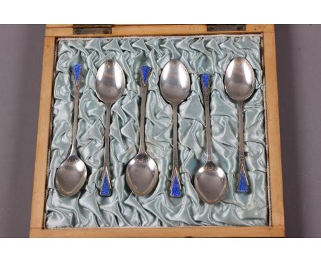 A set of six Art Deco silver and blue enamel coffee spoons, in silk lined mahogany box 