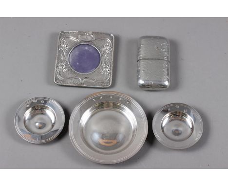 A pair of silver Armada dishes and a larger similar Armada dish, 5.3oz troy approx, an embossed silver photo frame and a pewt
