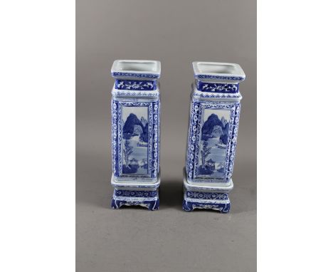 A pair of Chinese blue and white square landscape decorated jars with seal marks to base, on stands, 16 1/2" high