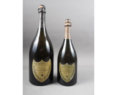 A Magnum bottle of Cuvée Don Perignon champagne, vintage 1980, and another regular sized bottle, vintage 1969