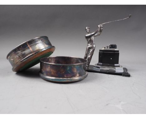 A pair of silver plated wine bottle coasters and a table lighter with stand, mounted golfer, 6 3/4" high overallCondition:Pai