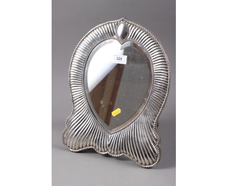 A silver framed shaped dressing table easel mirror with fluted design and heart-shaped bevelled plate 