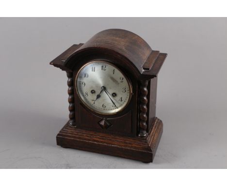 An oak cased arch top mantel clock with barley twist columns, silvered dial and Arabic numerals, 12 1/4" high, and a Kolster-