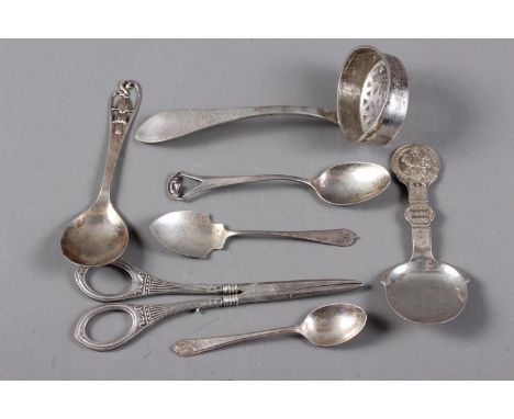 A pair of Danish silver grape scissors, a Danish silver sifter spoon, three English silver spoons and two Danish silver caddy