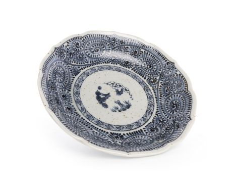LATE 19TH CENTURY CHINESE BLUE AND WHITE PLATE, with a central panel of bamboo and flowers in a border of swirling scroll des