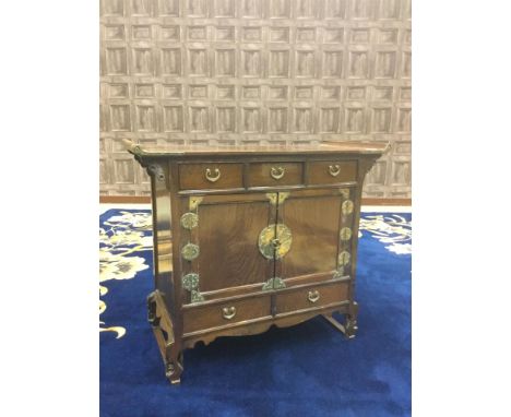 20TH CENTURY CHINESE STAINED WOOD CHEST, the rectangular top with scroll ends over three drawers, two cupboard doors and two 