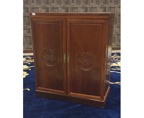 20TH CENTURY CHINESE HARDWOOD DRINKS CABINET, the hinged top and sides opening to reveal shelving and a wine rack, 182cm long