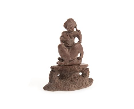 20TH CENTURY CHINESE CERAMIC FIGURE, modelled in the form of a man and foe dog, on a naturalistically modelled stand, 17cm hi
