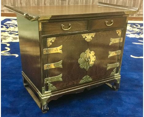 20TH CENTURY CHINESE STAINED WOOD CHEST, the rectangular top with scroll ends over two drawers and two cupboard doors, with b