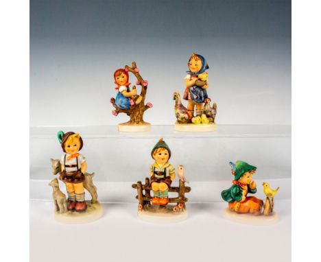 A set of 5 Goebel Hummel figurines that consists of a cheerful boy caring for a chick, a boy tending to two affectionate goat