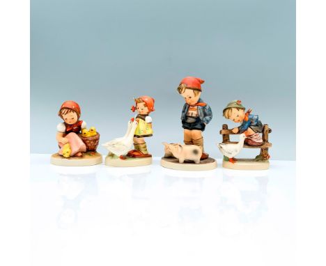 A set of four beautiful Hummel figurines of children with farm animals that consist of a young boy on a fence with a goose, a