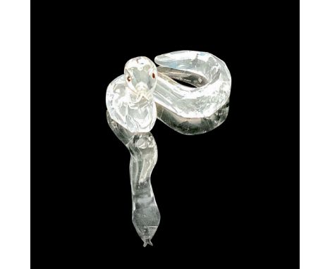 Faceted clear cut crystal, with black-colored beaded eyes and metal tongue. Swarovski backstamp. This item has its original b