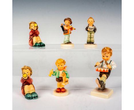 A set of 6 Goebel Hummel children figurines that are holding an instrument in their hands in an adorable and endearing pose. 