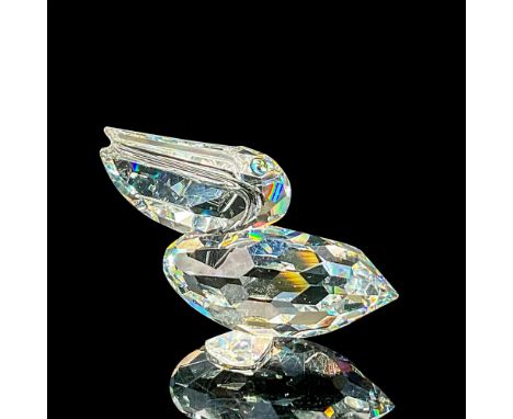 Modelled as a clear faceted water bird with blue-green eyes. Swarovski etched mark. This item has its original box 3.25"W x 2