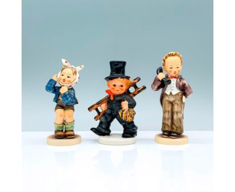 A set of three of figurines, one a boy in a black suit and top hat walking with a ladder in hand, a young boy in a fine brown