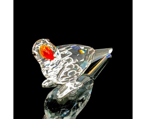Faceted clear cut crystal, with black-colored beaded eyes and yellow-orange gradient glass beak. Swarovski backstamp. This it