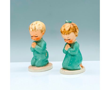 Beautiful figurines of a young blond boy and girl that are kneeling in prayer with their hands together wearing teal pajamas.