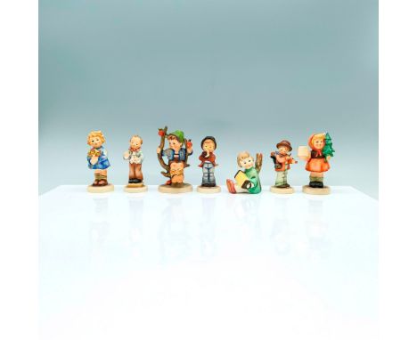 A set of 7 tiny Hummel figurines of multiple children in various activities from playing music, to exploring, to gardening. G