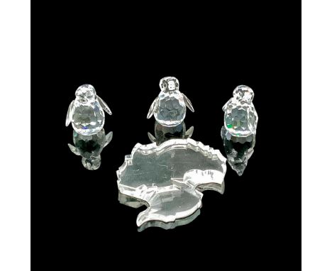 Faceted clear cut crystals, with black-colored dotted eyes. This item has a base included. Swarovski backstamp. This item has