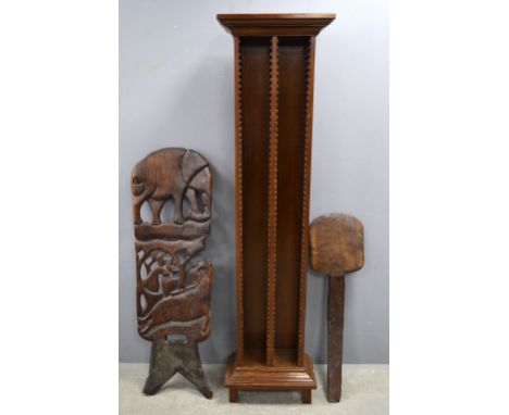 A carved African chair and a floor standing CD rack 
