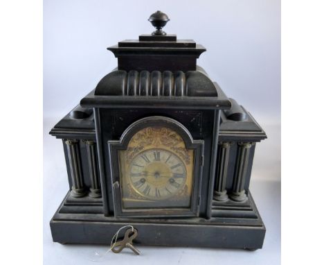Ebonised architectural mantel clock with brass dial with gilt metal spandrels, black roman numerals and two train movement.  