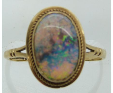 A 9ct gold ring set with an oval opal cabochon, 2g, size O