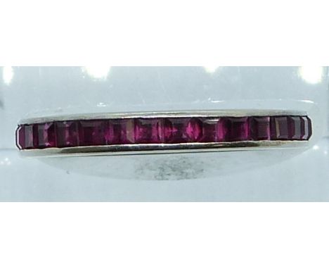 An 18ct white gold eternity ring set with square cut rubies, 1.5g, size M