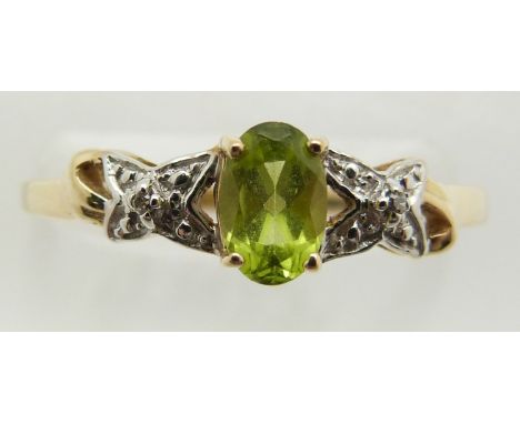 A 9ct gold ring set with an oval cut peridot and diamonds, 1.6g, size P