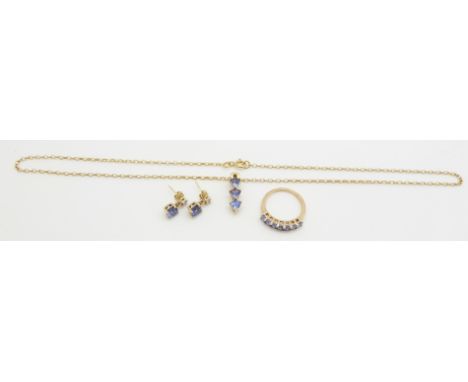 A suite of 9ct gold jewellery set with tanzanite, comprising earrings, pendant and ring