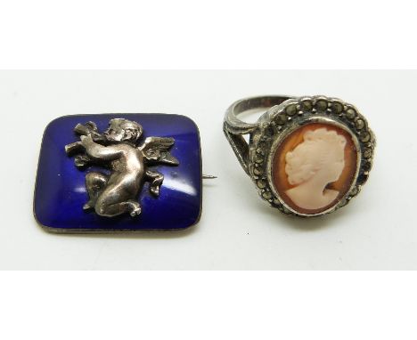 A silver brooch set with enamel depicting a cherub and a cameo ring