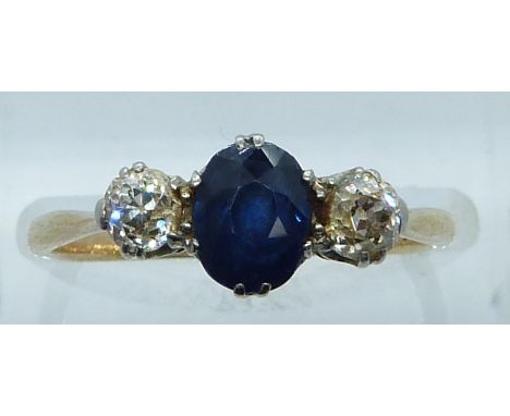 An 18ct gold ring set with an oval cut sapphire of approximately 0.65ct and diamonds each approx 0.15ct, 2.2g, size N&nbsp;