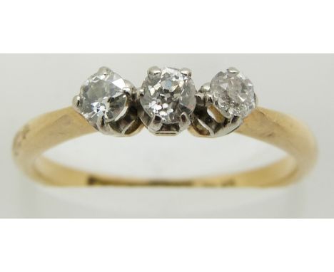 An 18ct gold ring set with three diamonds, 2.7g, size M