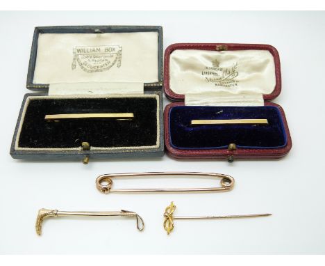 A 9ct gold riding crop brooch, two 9ct gold bar brooches, 9ct gold stick pin (7.3g), yellow metal safety pin, fox and crop br