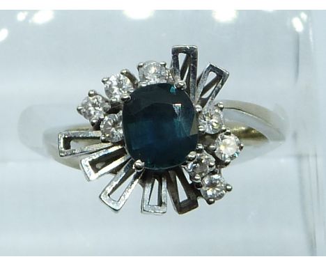 A white gold ring marked 14k set with a sapphire and diamonds, 4.5g, size J