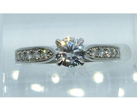 Mappin &amp; Webb platinum ring set with a round brilliant cut diamond of approximately 0.5ct and seven further round cut dia