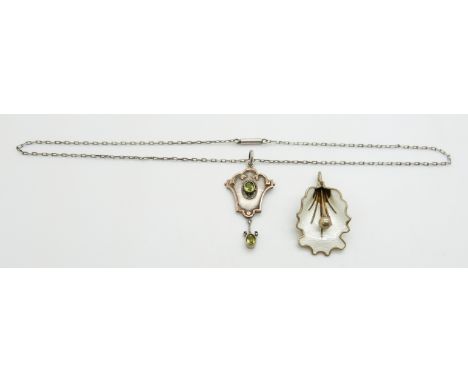 Norwegian silver pendant in the form of a lily set with white enamel and a silver and 9ct gold pendant set with peridot